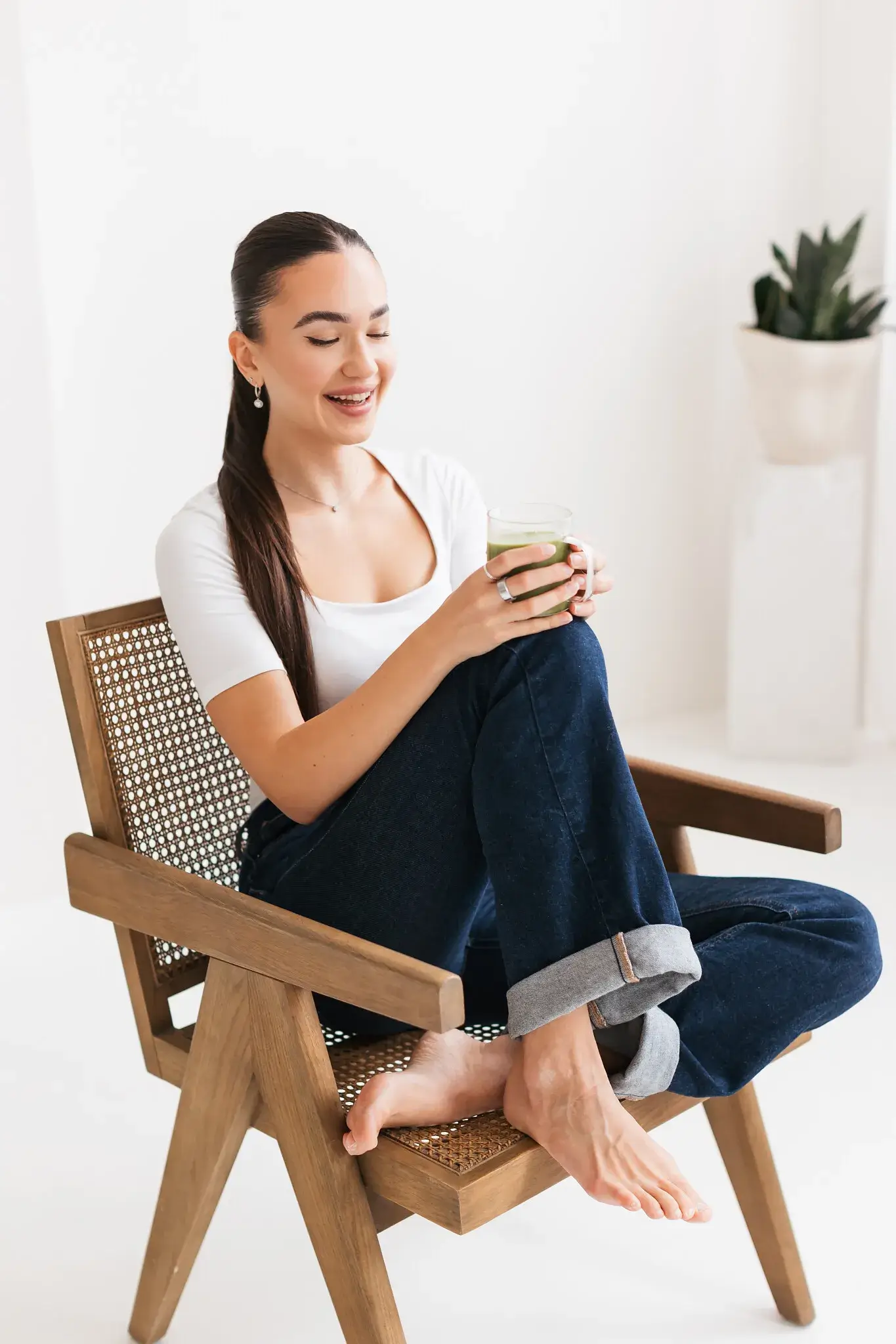 Erika sitting in a rattan chair